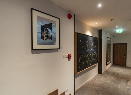 a hallway with two pictures on the wall at QUU HOTEL Chiang Mai in Chiang Mai