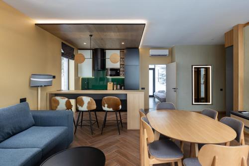 a living room with a couch and a table at Villas Fomich in Bukovel