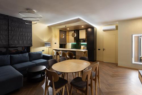 a living room with a couch and a table and chairs at Villas Fomich in Bukovel