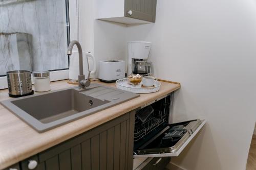 a kitchen with a sink and a counter top at Apartament Żeromskiego 1 in Sandomierz
