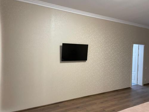 a flat screen tv on a wall in a room at Dvir Litynskyi in Lityn