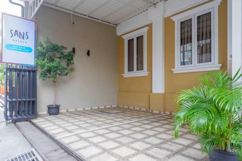 a house with a sign on the side of it at Sans Hotel Empress Simpang Lima in Semarang