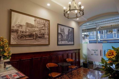 a waiting room with a table and a picture on the wall at Sans Hotel Empress Simpang Lima in Semarang