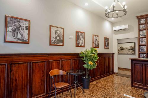 a room with wood paneling and a table and chairs at Sans Hotel Empress Simpang Lima in Semarang