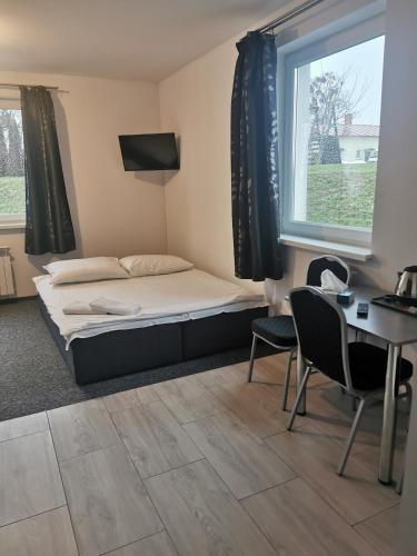 Ένα ή περισσότερα κρεβάτια σε δωμάτιο στο Pokoje Gościnne MAGNOLIA