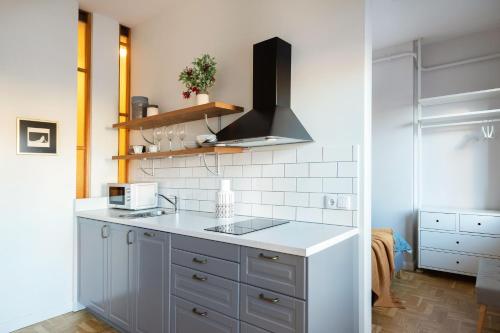 a kitchen with a white counter top and a sink at Art & Comfort Home in Kaunas