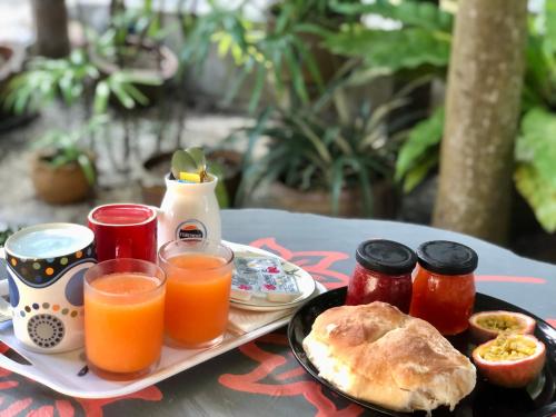 a tray of breakfast food with orange juice and toast at Angelot Villa in Chaweng Noi Beach