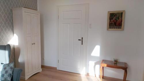 a room with a white door and a wooden table at Landlust Unser L ieblingscafe in Xanten