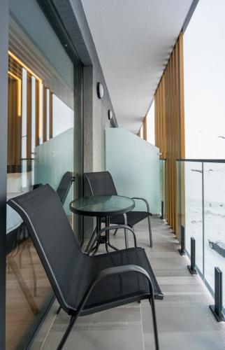 a meeting room with black chairs and a table at New Gudauri Atrium Ski and Dream Apartments in Gudauri