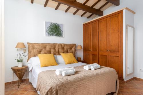 1 dormitorio con 1 cama grande y 2 toallas. en Villa Menorca Fucsia by Mauter Villas, en Cala'n Bosch