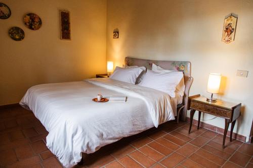 a bedroom with a bed with a tray on it at Poggio del Sole in Castiglione del Lago
