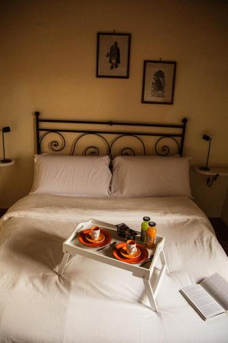 a tray of food on a bed with a table on it at Poggio del Sole in Castiglione del Lago