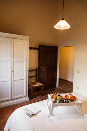 a room with a table with a tray of food on it at Poggio del Sole in Castiglione del Lago