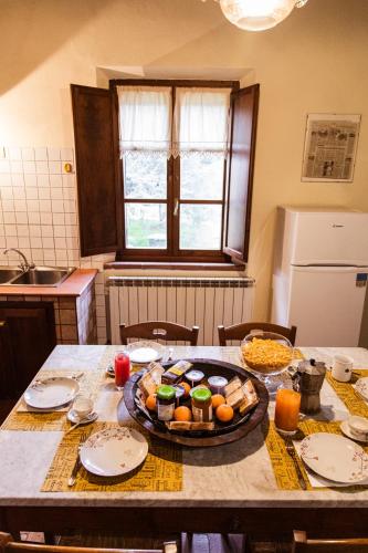 a kitchen table with a plate of food on it at Poggio del Sole in Castiglione del Lago