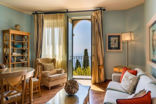 a living room with a couch and a table at Hotel Villa Carlotta in Taormina