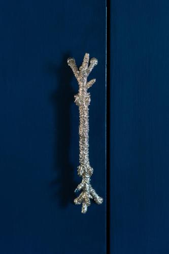 a silver object on a blue door with a shadow at Hotel Villa Carlotta in Taormina
