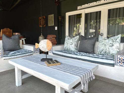 a white table with a lamp on top of it at Studio Gray in Benoni