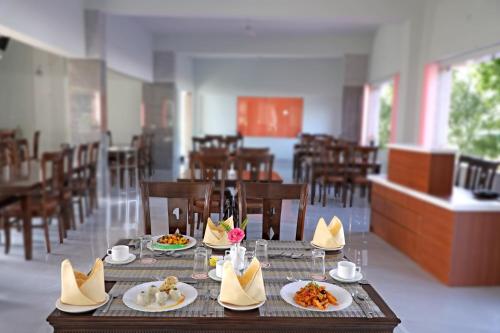 a dining room with a table with plates of food at Bamboo Saa Sunrrise Wedding & Wellness Resort, Jaipur in Jaipur