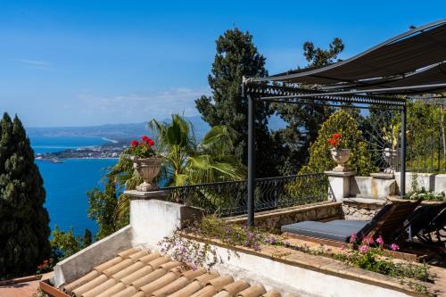 a view of the ocean from a house at Hotel Villa Carlotta in Taormina