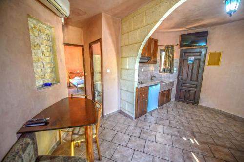 a kitchen with a table and a counter top at Anemomili Village in Kissamos