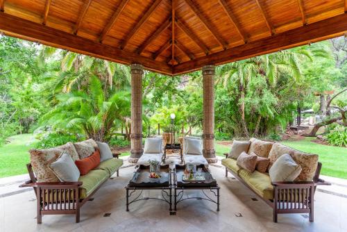 a porch with two couches and a table at Lejwe La Metsi Private Reserve in Bela-Bela