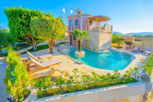 an aerial view of a house with a swimming pool at Anemomili Village in Kissamos