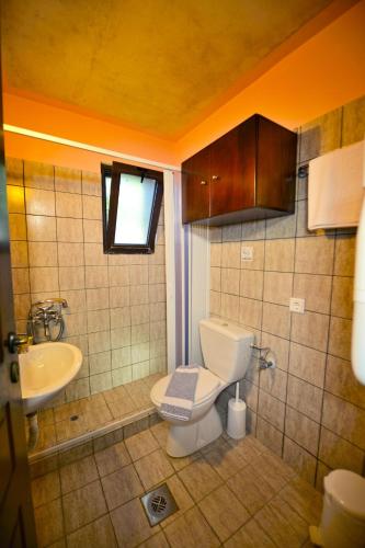 a bathroom with a toilet and a sink at Anemomili Village in Kissamos