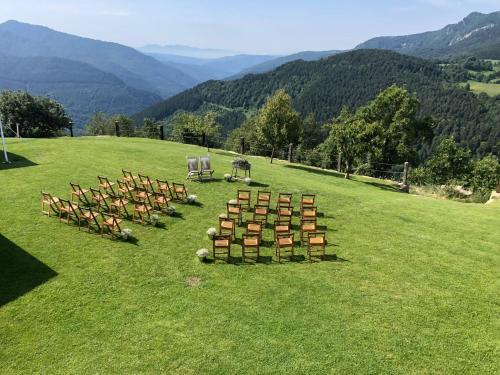 a row of chairs and tables on a field at CasaCampelles I - Vall de Núria - Ripollès in Campelles