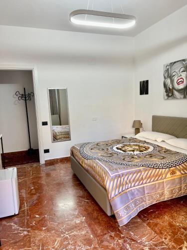 a bedroom with a large bed with a painting on the wall at Rooms lungomare in Crotone