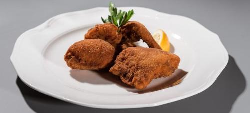 a white plate with fried food on a table at Pr Kopač in Brezovica