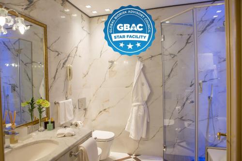 a bathroom with a toilet, sink, and bathtub at Grand Hotel Majestic gia' Baglioni in Bologna