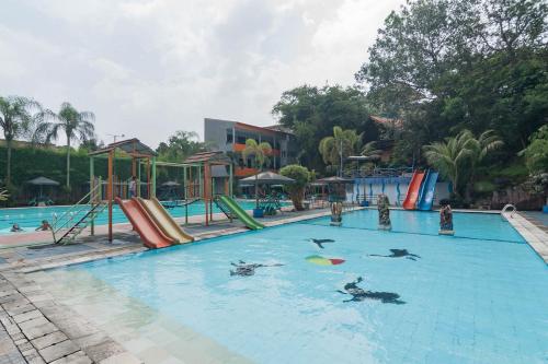 a large swimming pool with people playing in the water at Urbanview Hotel Sagara Bogor in Bogor