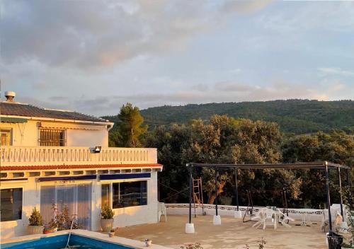 a house with a swimming pool and a patio at Habitaciones en casa rural particular La Casita in Ibi