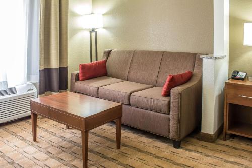 a living room with a couch and a coffee table at Comfort Inn & Suites Cedar Rapids North - Collins Road in Cedar Rapids