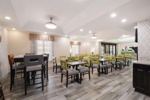 a dining room with tables and yellow chairs at Quality Inn Alcoa Knoxville in Alcoa