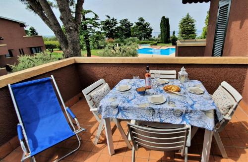 a table and chairs sitting on a patio at APARTMENTS BLUE VIEW - Regarda Travel in Bardolino