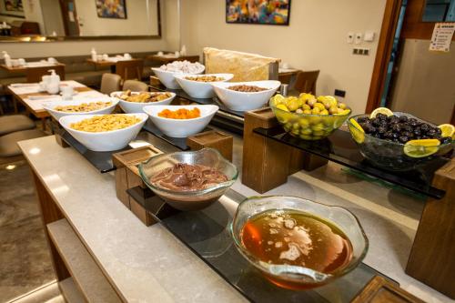 a buffet with bowls of food on a table at Erboy Hotel Istanbul Sirkeci in Istanbul