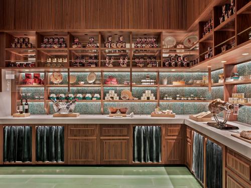 a kitchen with wooden cabinets and shelves with vases at Hotel Colón Gran Meliá - The Leading Hotels of the World in Seville