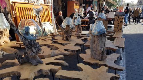 a group of tree stump sculptures on a street at Jaffa Getaway sea front, luxury Duplex, Port & Old City 2m walk in Tel Aviv