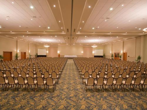 an empty banquet hall with rows of chairs and a stage at Paradise Village in Nuevo Vallarta 
