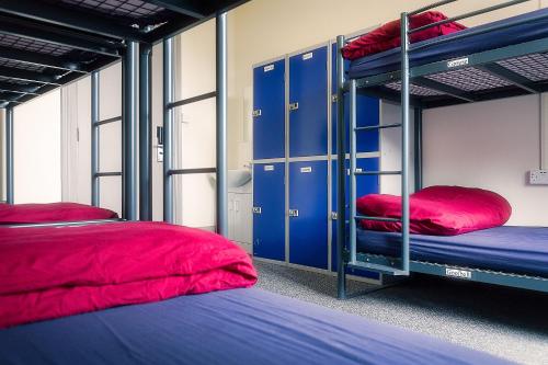 a room with two bunk beds and blue lockers at Princes Street Hostel in Edinburgh