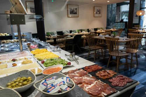 a buffet of food on a table in a restaurant at Petit Palace Plaza de la Reina in Valencia