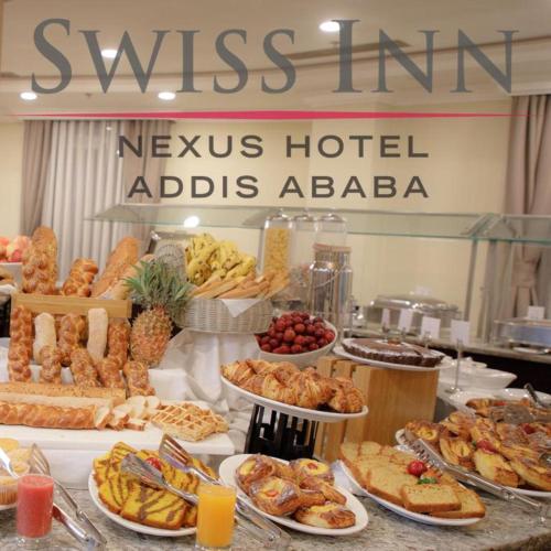a buffet with many different types of food on a table at Swiss Inn Nexus Hotel in Addis Ababa