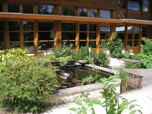 a building with a pond in front of it at Le Clos Chedeville in Chartres