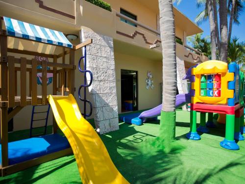 a childrens play area with a slide and a playground at Paradise Village in Nuevo Vallarta 