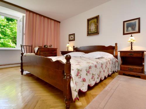 a bedroom with a large bed and a window at Holiday Home Stara Lipa in Baška Voda
