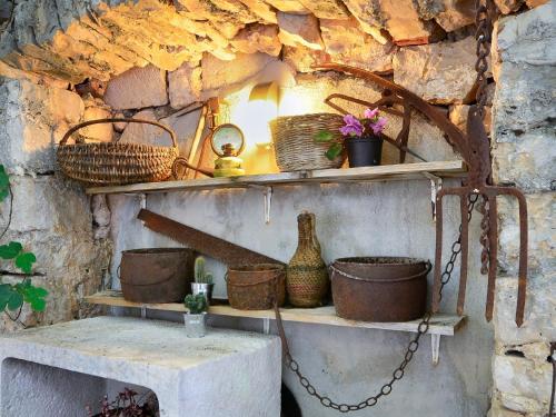a shelf with baskets and vases on it at Holiday Home Stara Lipa in Baška Voda