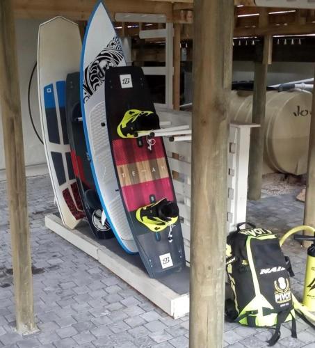 a group of snowboards sitting on a rack at Bentley's Guesthouse in Bloubergstrand