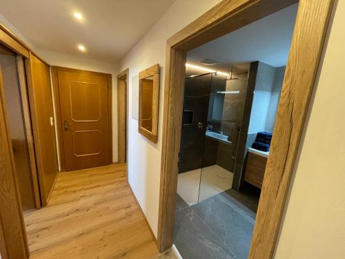 a hallway with a glass door leading to a kitchen at Landhaus Zillertal in Ramsau im Zillertal