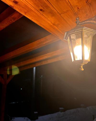 a light hanging from a wooden ceiling at Mount House Mavrovo in Mavrovo